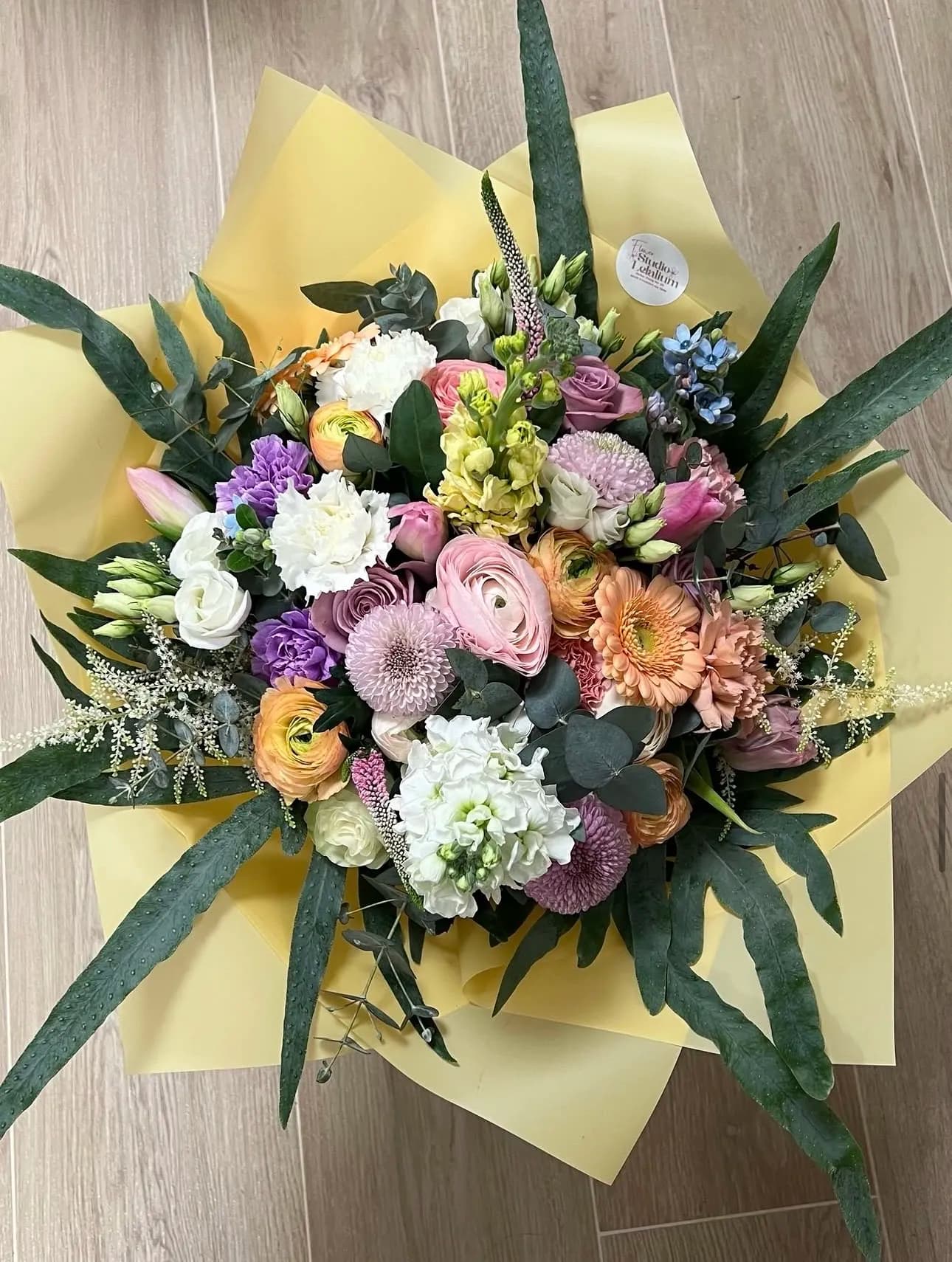 Farbenfroher saisonaler Strauß in Gelb und Rosa